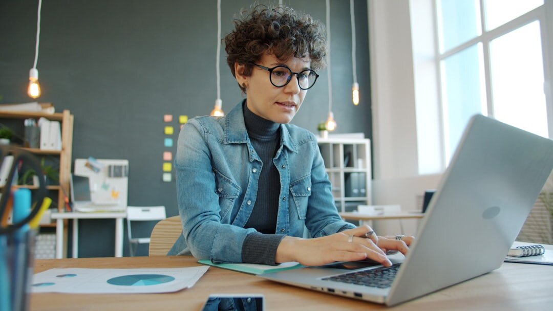 Person typing on laptop in modern workspace